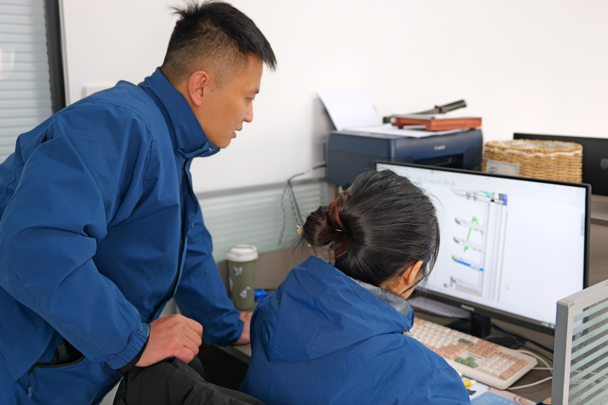 engineers reviewing 3D model of a medical endoscope cart during product development